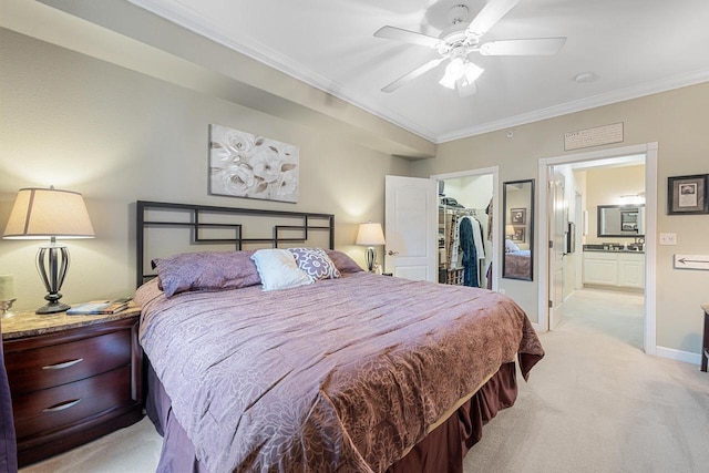 bedroom with light colored carpet, baseboards, a closet, a spacious closet, and ornamental molding