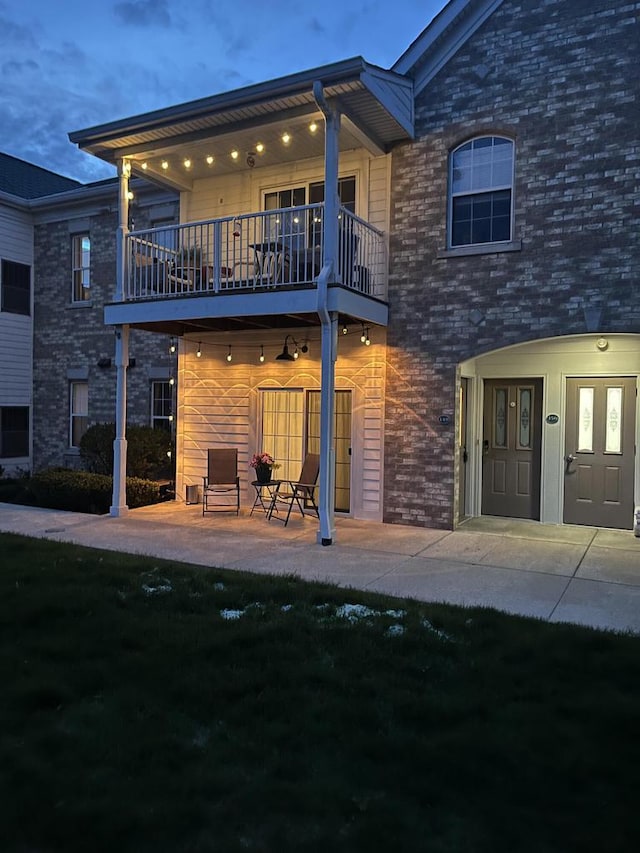 back of property with a patio area and a balcony