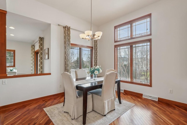 dining area with visible vents, baseboards, a chandelier, and a wealth of natural light