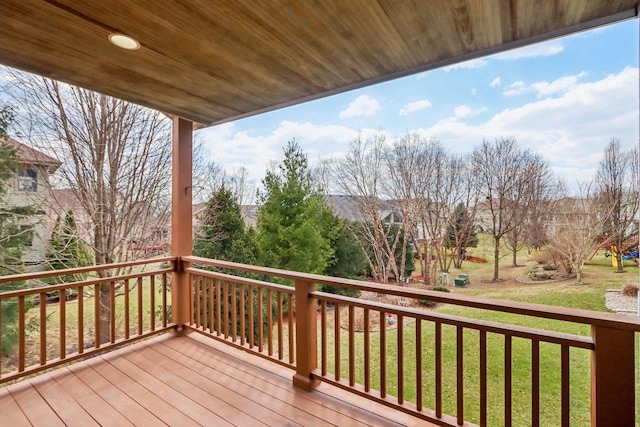 wooden deck featuring a yard