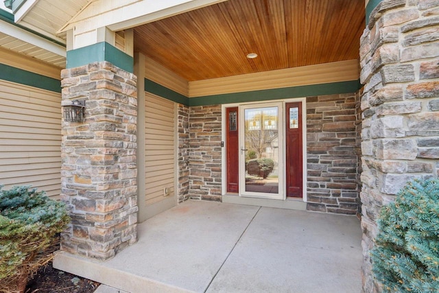 property entrance featuring a porch and stone siding