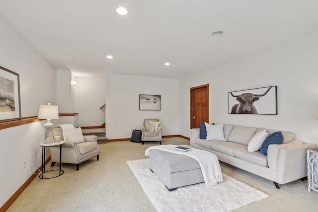 living room with recessed lighting, baseboards, light carpet, and stairway