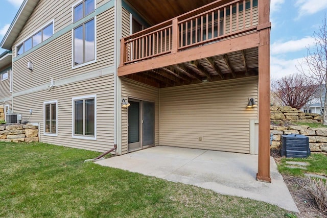 rear view of house featuring a yard, a patio, and cooling unit