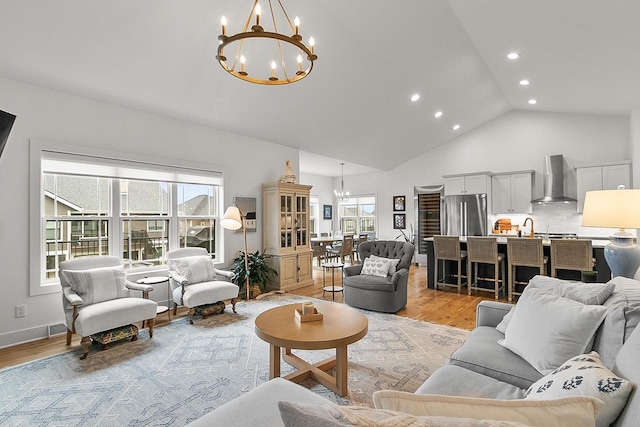 living area featuring recessed lighting, high vaulted ceiling, a chandelier, and light wood-type flooring