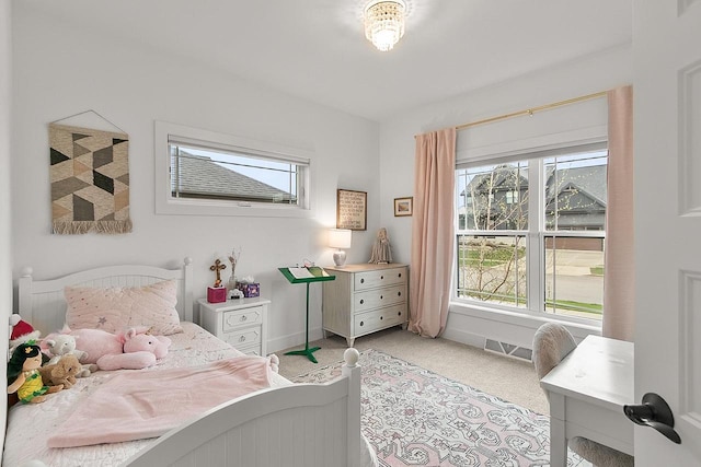 bedroom featuring visible vents, baseboards, and light colored carpet