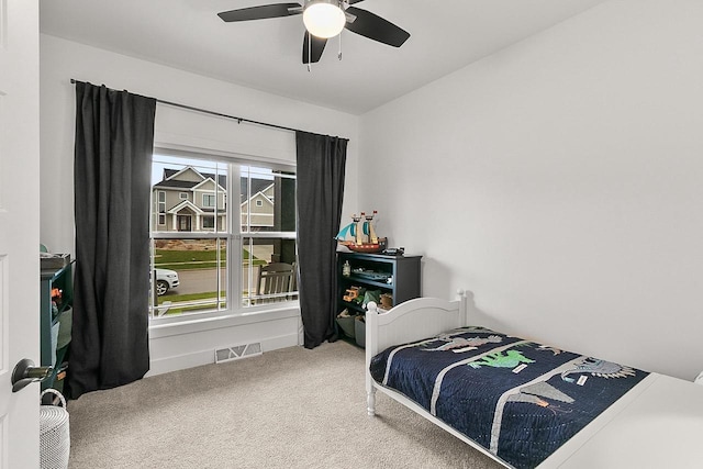 bedroom featuring carpet floors, a ceiling fan, and visible vents