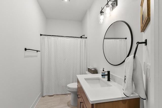 full bath with vanity, baseboards, and toilet
