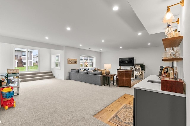 living room with recessed lighting and light colored carpet