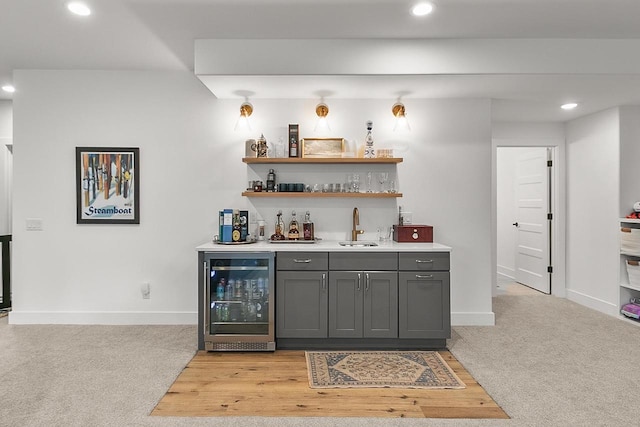 bar with wine cooler, recessed lighting, wet bar, and a sink