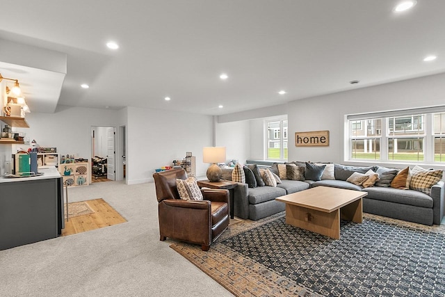living area featuring recessed lighting and light carpet