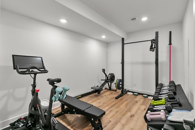 workout room with light wood-style floors, recessed lighting, and baseboards