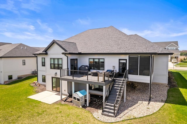 back of house featuring stairs, a shingled roof, a wooden deck, a patio area, and a yard