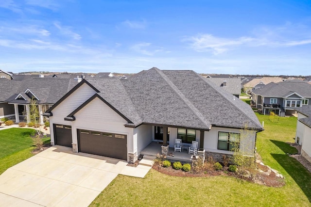 view of front of house with covered porch, a residential view, a garage, a front lawn, and concrete driveway