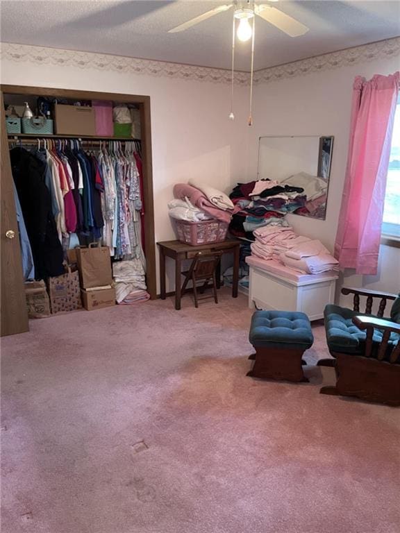 carpeted bedroom with a closet and a ceiling fan