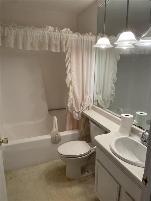 bathroom featuring toilet, shower / tub combo, and vanity