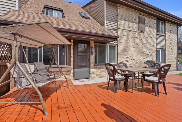 wooden terrace with outdoor dining space