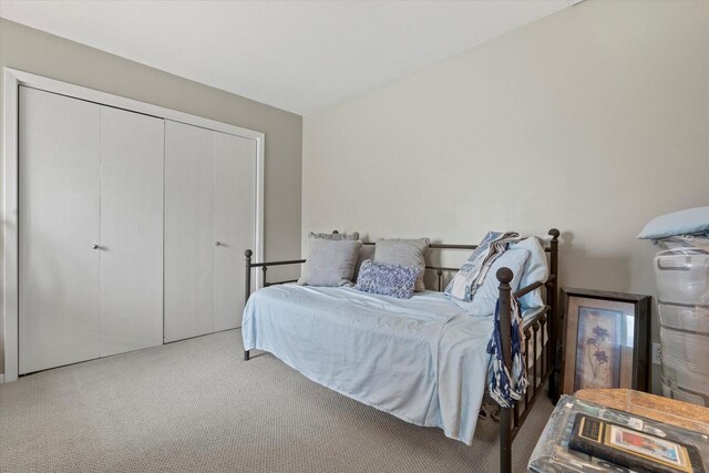 carpeted bedroom with a closet
