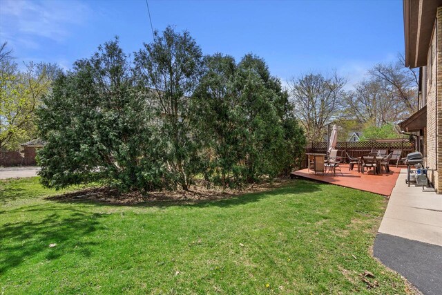 view of yard with fence and a deck