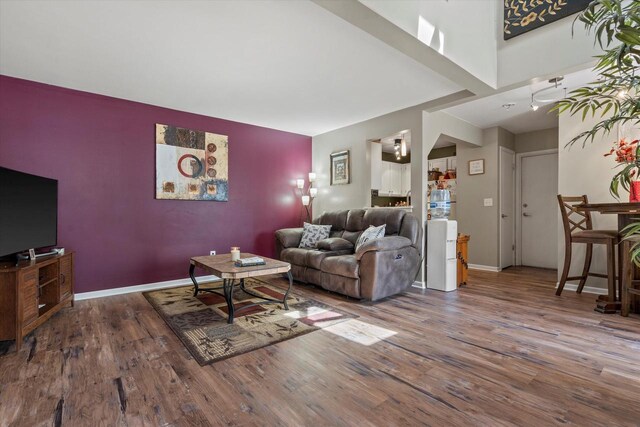 living room with baseboards and wood finished floors