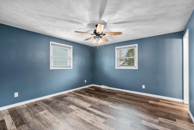 unfurnished room featuring baseboards, a ceiling fan, and wood finished floors