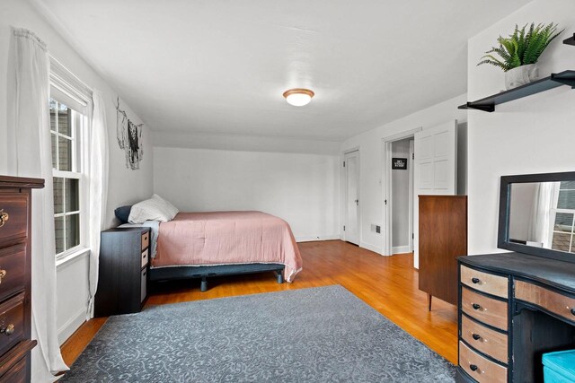 bedroom featuring baseboards and wood finished floors