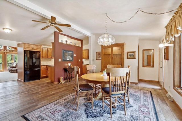 W11027B County Road O, Portage, WI 53901 - dining area featuring light wood-style flooring, a chandelier, a ceiling fan, and baseboards