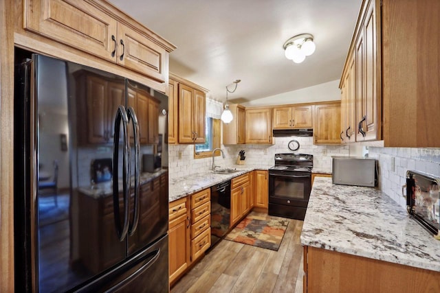 W11027B County Road O, Portage, WI 53901 - kitchen with black appliances, a sink, lofted ceiling, under cabinet range hood, and light wood-type flooring