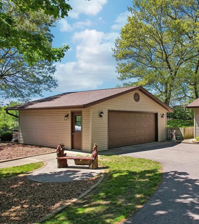 W11027B County Road O, Portage, WI 53901 - view of front of property with fence, a garage, and asphalt driveway