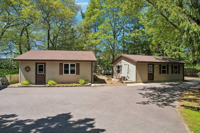 W11027B County Road O, Portage, WI 53901 - view of front of house featuring an outdoor structure, fence, cooling unit, and asphalt driveway