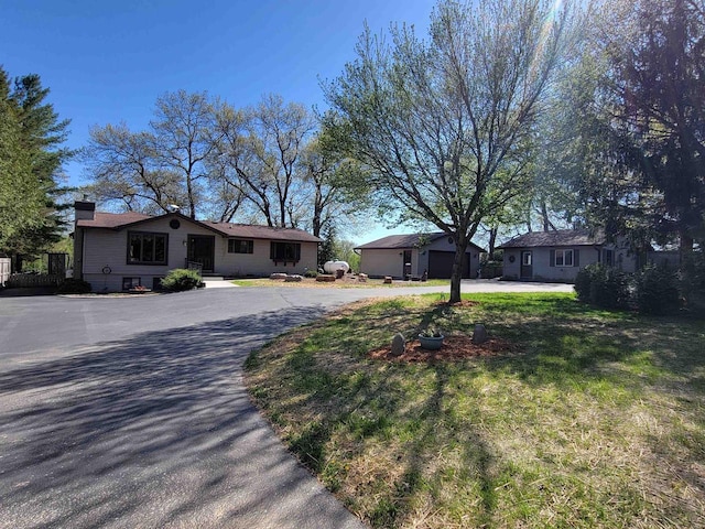 W11027B County Road O, Portage, WI 53901 - single story home with curved driveway, a chimney, and a garage