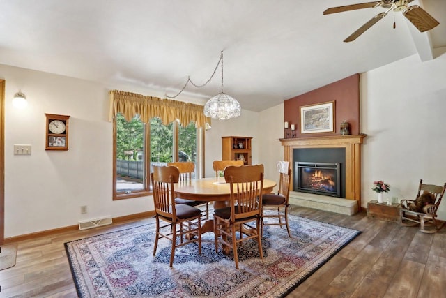 W11027B County Road O, Portage, WI 53901 - dining space featuring wood finished floors, lofted ceiling, a chandelier, ceiling fan, and baseboards