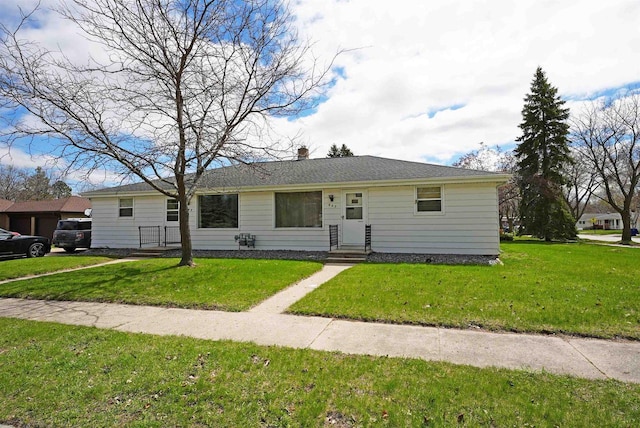 ranch-style house with entry steps and a front yard