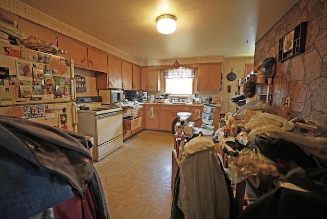 kitchen with light countertops, white range with electric stovetop, and light floors