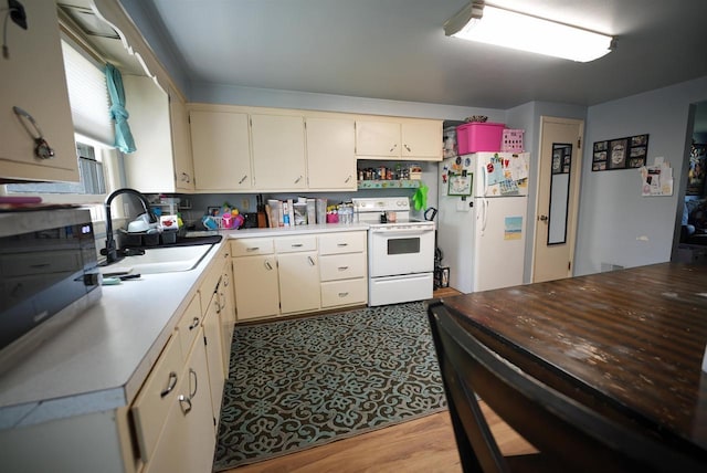 kitchen with open shelves, a sink, white appliances, light countertops, and cream cabinetry