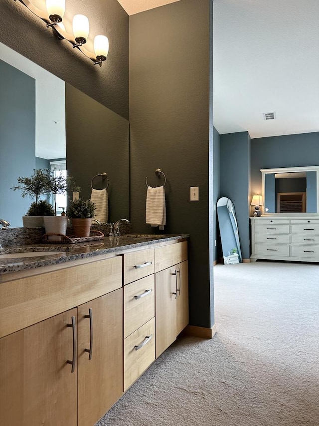 bathroom with visible vents, baseboards, and vanity