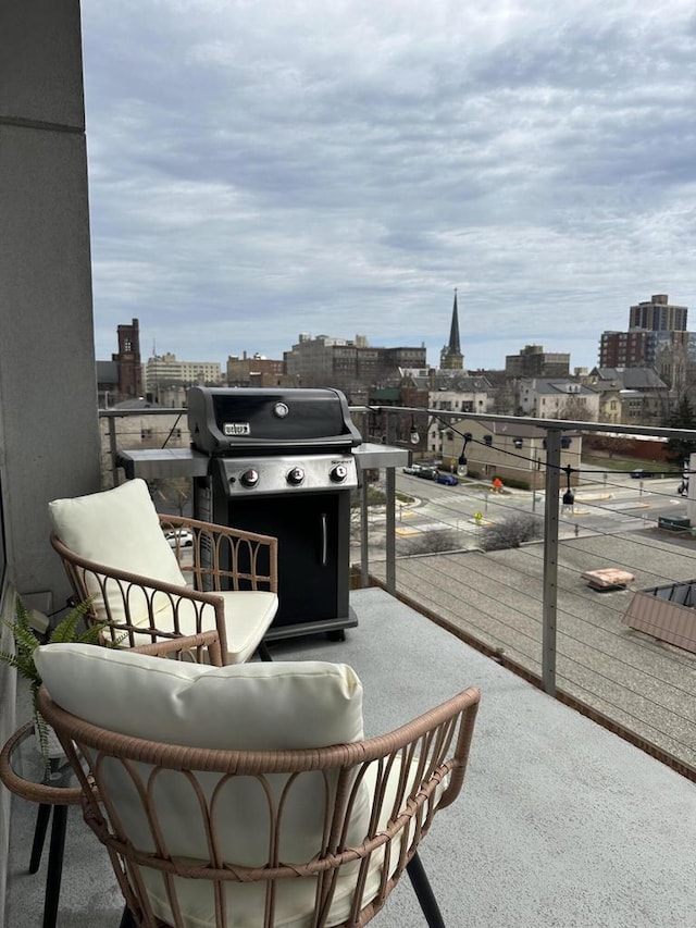balcony featuring a city view and area for grilling