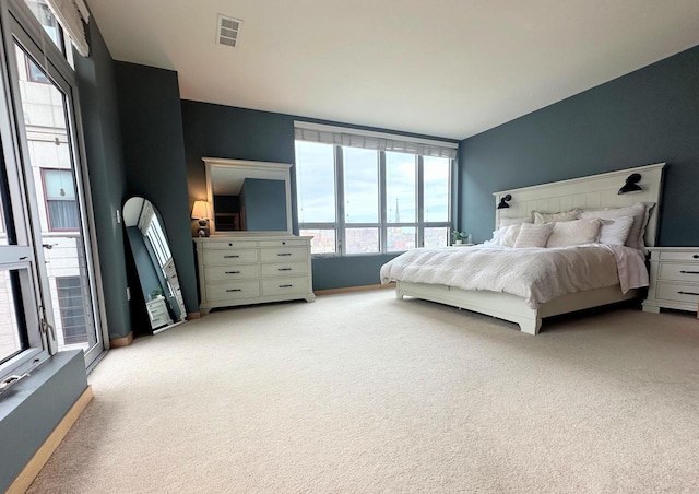 bedroom featuring light carpet and visible vents