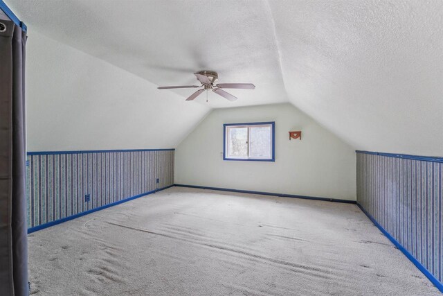 W7126 N Oakwood Cir, Neshkoro, WI 54960 - additional living space featuring a ceiling fan, carpet floors, a textured ceiling, baseboards, and vaulted ceiling