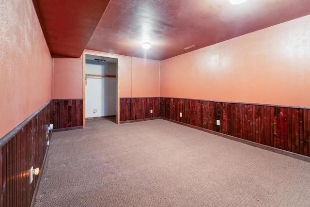 W7126 N Oakwood Cir, Neshkoro, WI 54960 - carpeted empty room featuring a wainscoted wall and wood walls