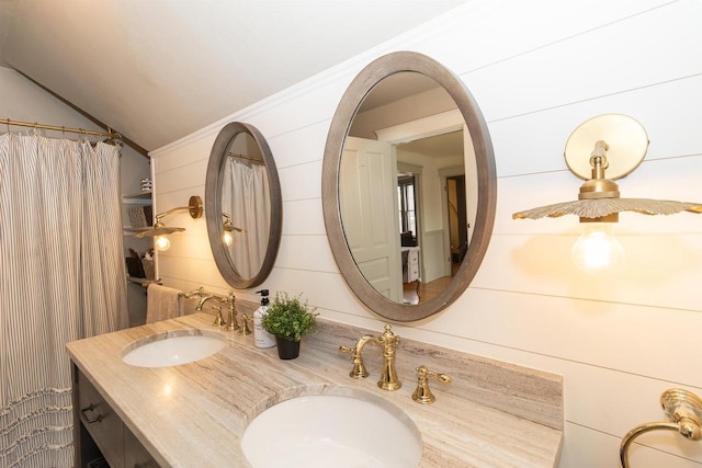 full bathroom featuring double vanity, a sink, and vaulted ceiling
