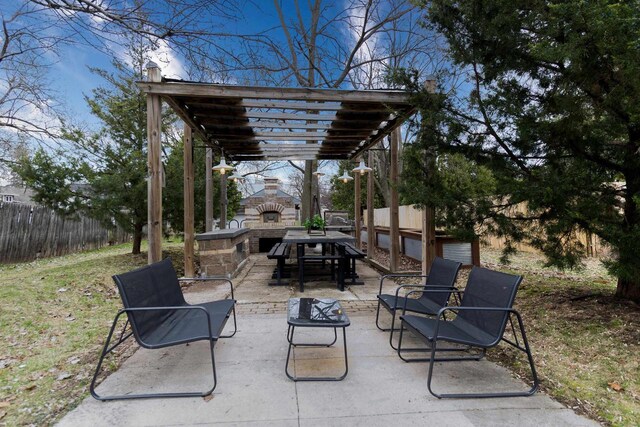 view of patio featuring fence, a pergola, and an outdoor stone fireplace