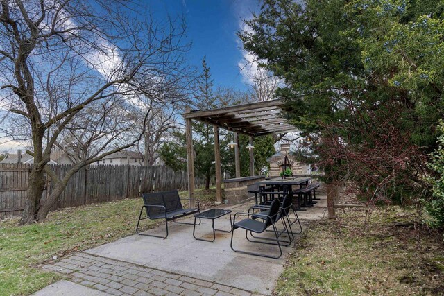 view of patio / terrace with a pergola and fence