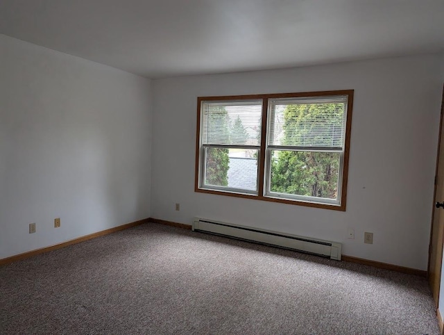 empty room featuring carpet flooring, baseboards, and a baseboard radiator