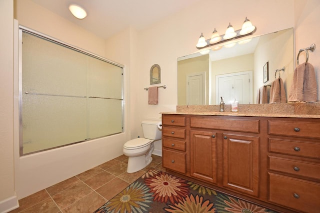full bath with tile patterned flooring, combined bath / shower with glass door, toilet, and vanity