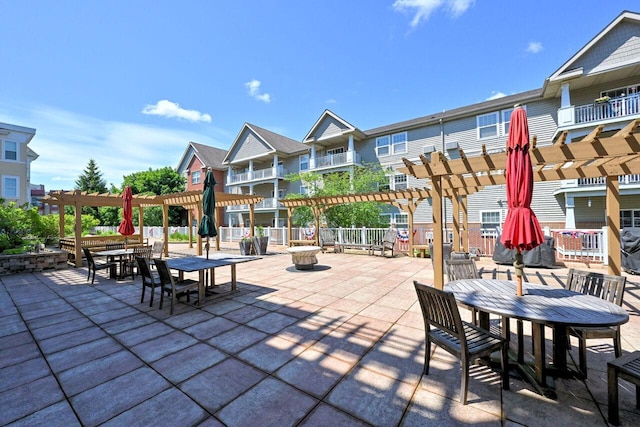 view of patio featuring a pergola, a residential view, and outdoor dining area