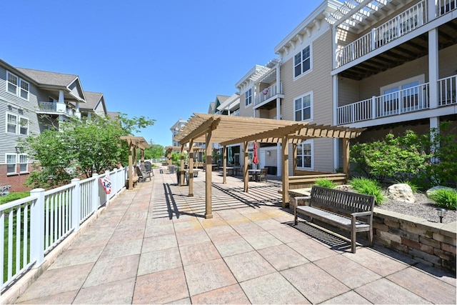 view of property's community with a pergola and a patio area