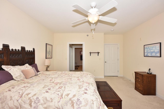 bedroom with a ceiling fan, baseboards, and light colored carpet