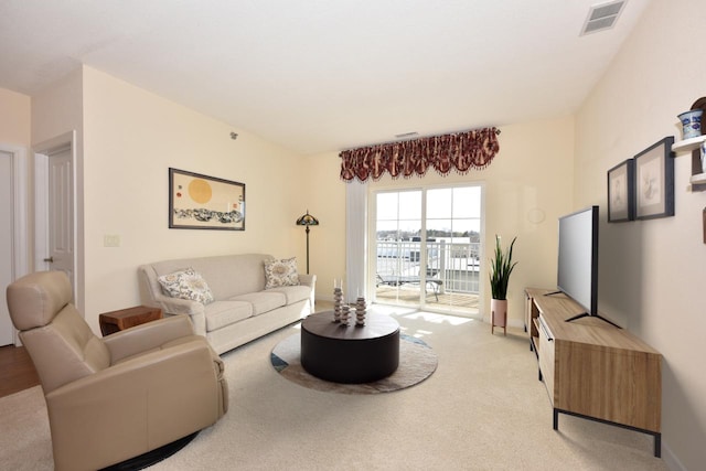 carpeted living room with baseboards and visible vents