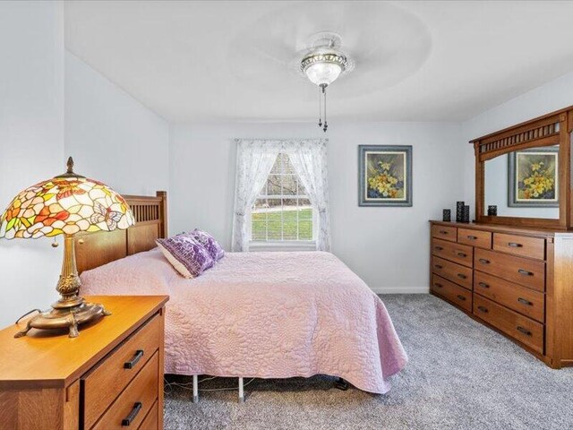 bedroom with carpet floors, baseboards, and ceiling fan