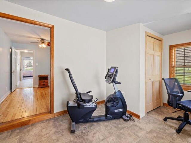 workout area with baseboards and ceiling fan